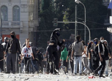 Protesters throw stones in Athens' main Syntagma Square, during violent demonstrations on Thursday