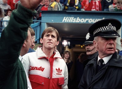 Liverpool manager Kenny Dalglish looks on as events unfold at the Leppings Lane end of the stadium.