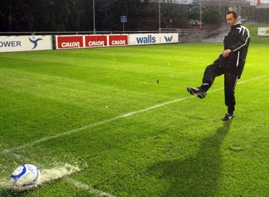 Referee Neil Doyle inspects the playing surface at the UCD Bowl before calling the game off last night.