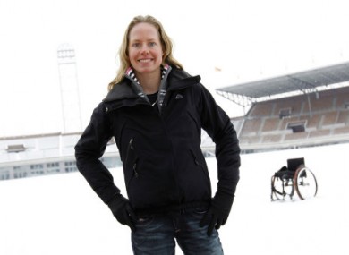 van der Vorst stands in front of her wheelchair at the Olympic Stadium in Amsterdam.