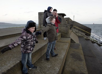 The Licken family - Cormac, Rory, Colm and Aiden - from Raheny braving the wind at Dollymount in Dublin today. Met Eireann has issued a gale warning for the country.