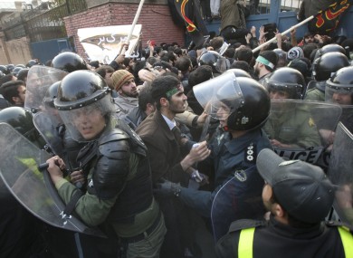 Iranian protesters scuffle with police officers as they try to enter the British Embassy, in Tehran, Iran, Tuesday, Nov. 29, 2011