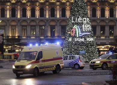 An ambulance leaves the scene after yesterday's shootings in Place Saint-Lambert, Liège, where four people were killed. Six people in total died in yesterday's attack.