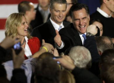 Former Massachusetts Governor Mitt Romney greets supporters during the Iowa caucus.
