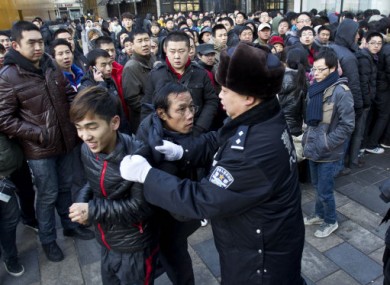 Police pulling people away from the Apple store in Beijing this morning.