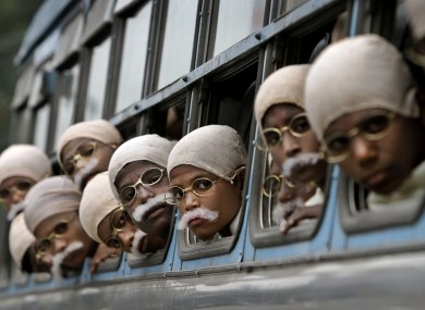 Underprivileged Indian children dressed as Mahatma Gandhi arrive for a world record attempt in Kolkata, India.