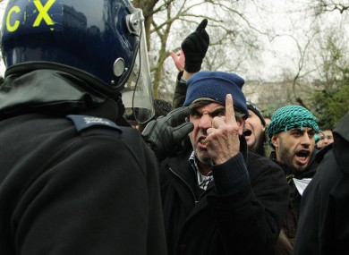 Anti-Assad protesters clash with police outside the Syrian Embassy in London.