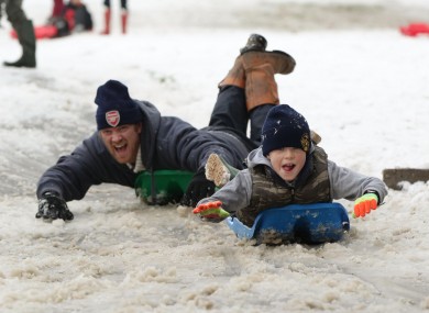 People sledge down Primrose Hill in London as heavy snowfall caused travel disruption across much of Britain today.