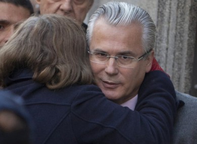 An unidentified woman embraces Spanish judge Baltazar Garzon as he arrives at the Supreme Court in Madrid on 31 January.