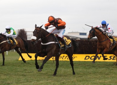 Long Run ridden by Sam Waley Cohen clears the last fence to win the The Betfair Denamn Steeple Chase.