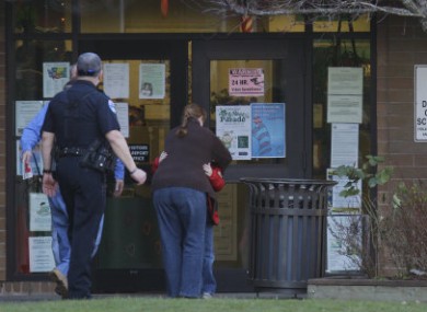 A child hugs an adult near the entrance to the school in Bremerton after yesterday's shooting.