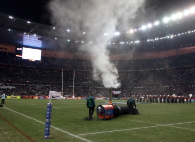 Stadium staff try to defrost the Stade de France pitch before the France v Ireland rugby international was called off.