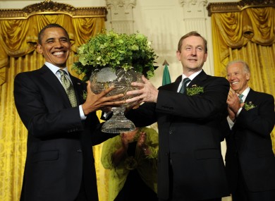 Enda Kenny presents Barack Obama with a bowl of shamrock in the White House yesterday, as vice-president Joe Biden watches.
