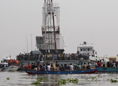 Rescuers search for victims of a ferry accident on the Meghna River in Munshiganj district, about 32 kilometers (20 miles) south of Dhaka, India