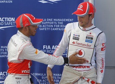 Lewis Hamilton (L) and teammate Jenson Button share a moment.