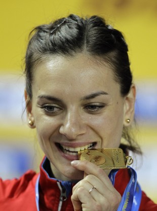 Isinbayeva bites her gold medal during the World Indoor Athletics Championships in Istanbul earlier this year.