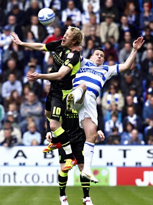 Leeds' Luciano Becchio wins the ball ahead of Reading's Ian Harte during today's clash.