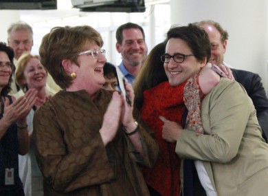 Executive AP editor Kathleen Carroll, left, applauds as reporter Adam Goldman, centre, is hugged after winning the Pulitzer Prize for Investigative Reporting.