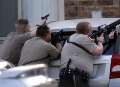 Officers responding to the emergency calls following yesterday's shooting and kidnapping.