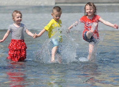 Two-year-old Lucy Beck (left), Callum Beck, aged three and Ruby Beck, aged four, enjoy the water at City Park, Bradford today.