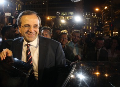 Leader of the New Democracy conservative party Antonis Samaras leaves an elections kiosk after speaking to his supporters at Syntagma square in Athens, Sunday, June 17, 2012