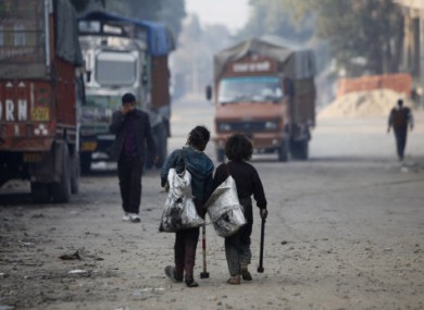 File photo of Indian 'rag picker children' who scour car yards for recyclable parts.
