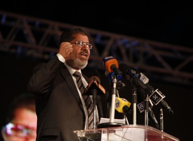 Mohammed Mursi speaks at a rally in Cairo last night as his side claimed victory in the presidential election.