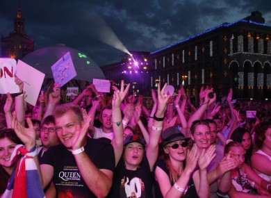 People react during a performance from musician Elton John at a Fan Zone during the Euro 2012 soccer championship in Kiev.