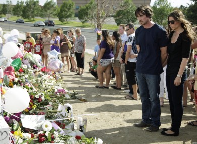 Christian Bale and his wife Sibi Blazic visit the memorial in Aurora, Colorado.