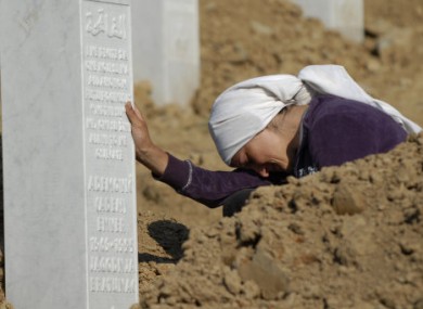 A Bosnian Muslim woman by her relative's graveside at the Potocari memorial, near the former UN base site.