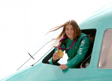 Katie Taylor shows off her Olympic gold medal from the cockpit.