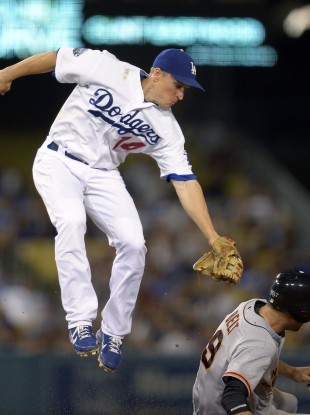 San Francisco Giants' Brandon Belt, right, steals second as Los Angeles Dodgers second baseman Mark Ellis in LA last night.