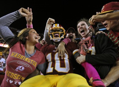RG3 celebrates with Redskins fans after running in a 76-yard touchdown on Sunday.