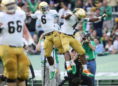 George Atkinson III (left) of Notre Dame celebrates scoring a touchdown with teammate Theo Riddick.