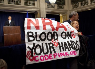 Activist Medea Benjamin, of Code Pink, is led away by security as she protests during the statement.