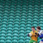 Not exactly a crowd-puller in Ballybofey. A lone spectator watches on as Stephen Griffin is tackled by Ronan McNally.