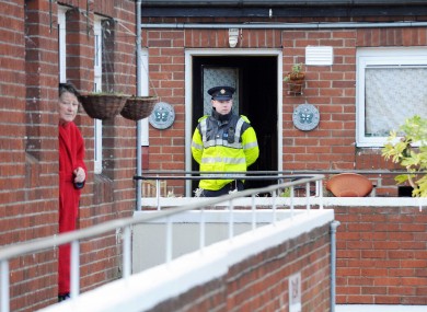 A garda stands watch outside the house in Stoneybatter where the couple were found dead this lunchtime.