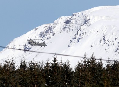 A Royal Air Force helicopter, in the Glens of Antrim, which has started dropping feed to thousands of farm animals.