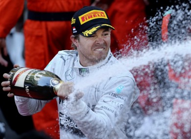 Nico Rosberg showers his pit crew with winners' champagne.
