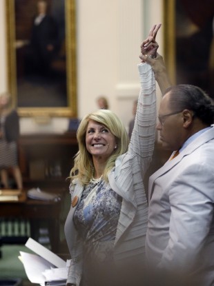 Wendy Davis points to supporters as times expires and her marathon filibuster comes to an end