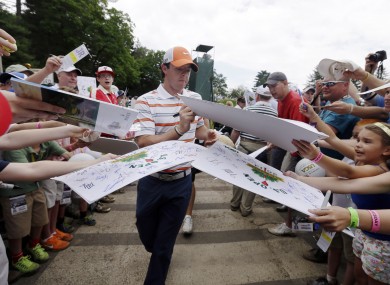 McIlroy signs autographs for fans during practice for the US Open.