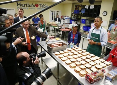 President Barack Obama speaks to reporters today as he visits Martha's Table, which prepares meals for the poor