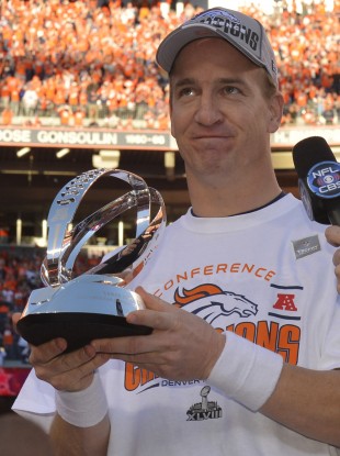 Denver Broncos quarterback Peyton Manning holds the trophy.