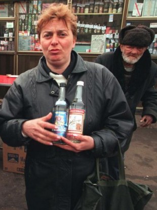 A Moscow woman holds two bottles of Russian-made vodka in downtown Moscow in 1997.