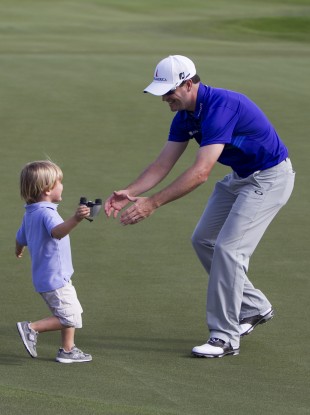 Johnson (the big lad on the right) celebrates with his three-year-old son Wyatt.