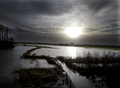 Floody hell: A watery winter sun rises above storm-ravaged countryside on the Kildare/Laois border on 2 January this year.