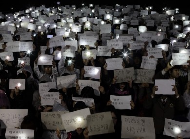 Danwon High School students hold papers with messages such as