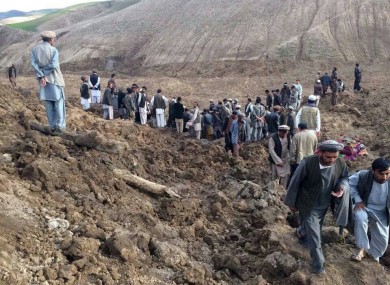 Afghans search for survivors after a massive landslide landslide buried a village.