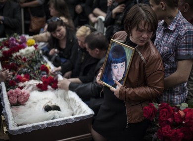 Mourners at the funeral of a 21-year-old believed to be killed by shots from a Ukrainian military column.