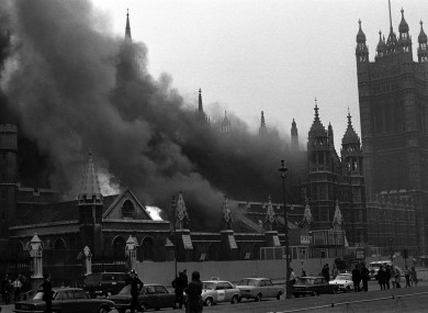 Flames leap amid the smoke pouring from the House of Commons after the bomb blast in the crypt chapel.